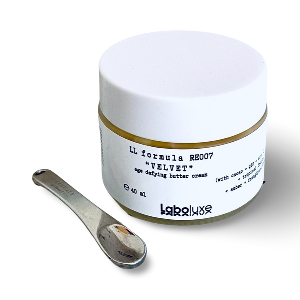 Velvet Age Defying Radiance Enhancer Butter Cream jar with spoon accessory.